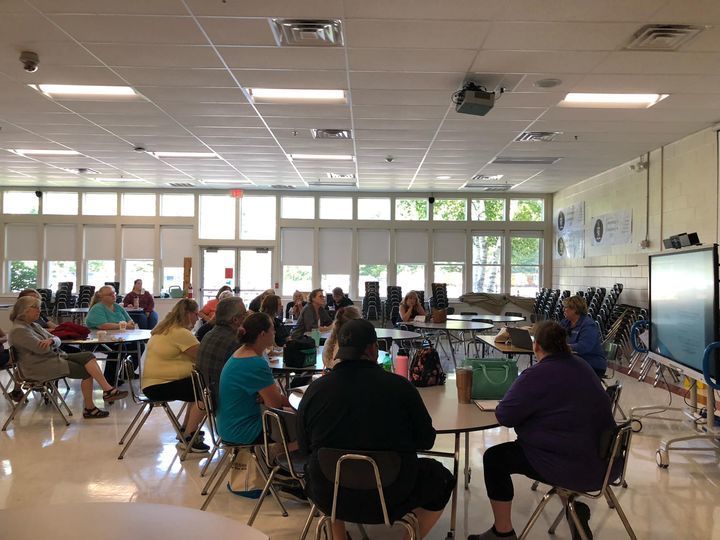 staff sitting at tables in training